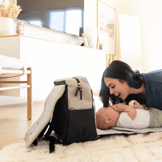 Mom changing baby's diaper.