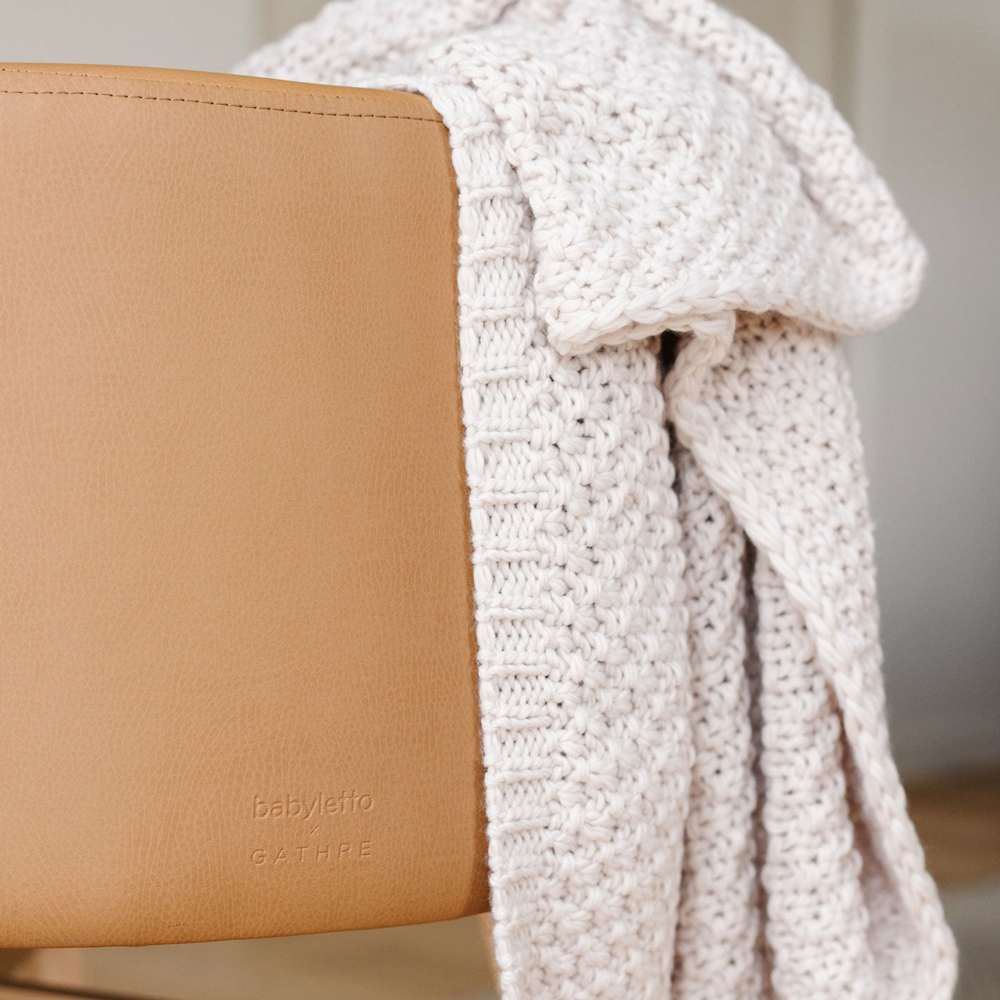Blanket draped over Babyletto x GATHRE Capsule Bassinet - Camel
