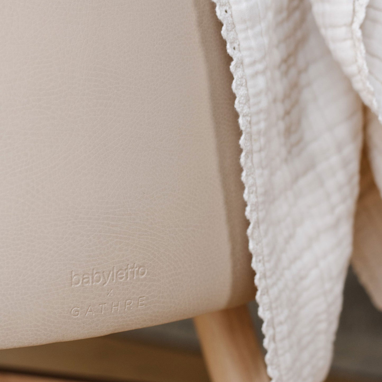 Blanket draped over Babyletto x GATHRE Capsule Bassinet - Millet