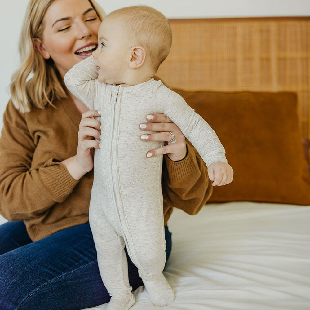 Baby wearing Copper Pearl Zip-up Footie - Oat