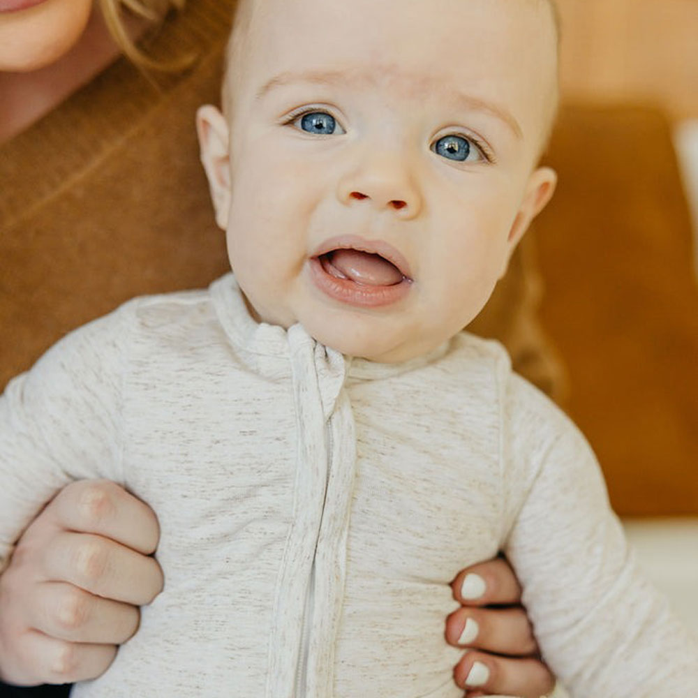 Baby wearing Copper Pearl Zip-up Footie - Oat