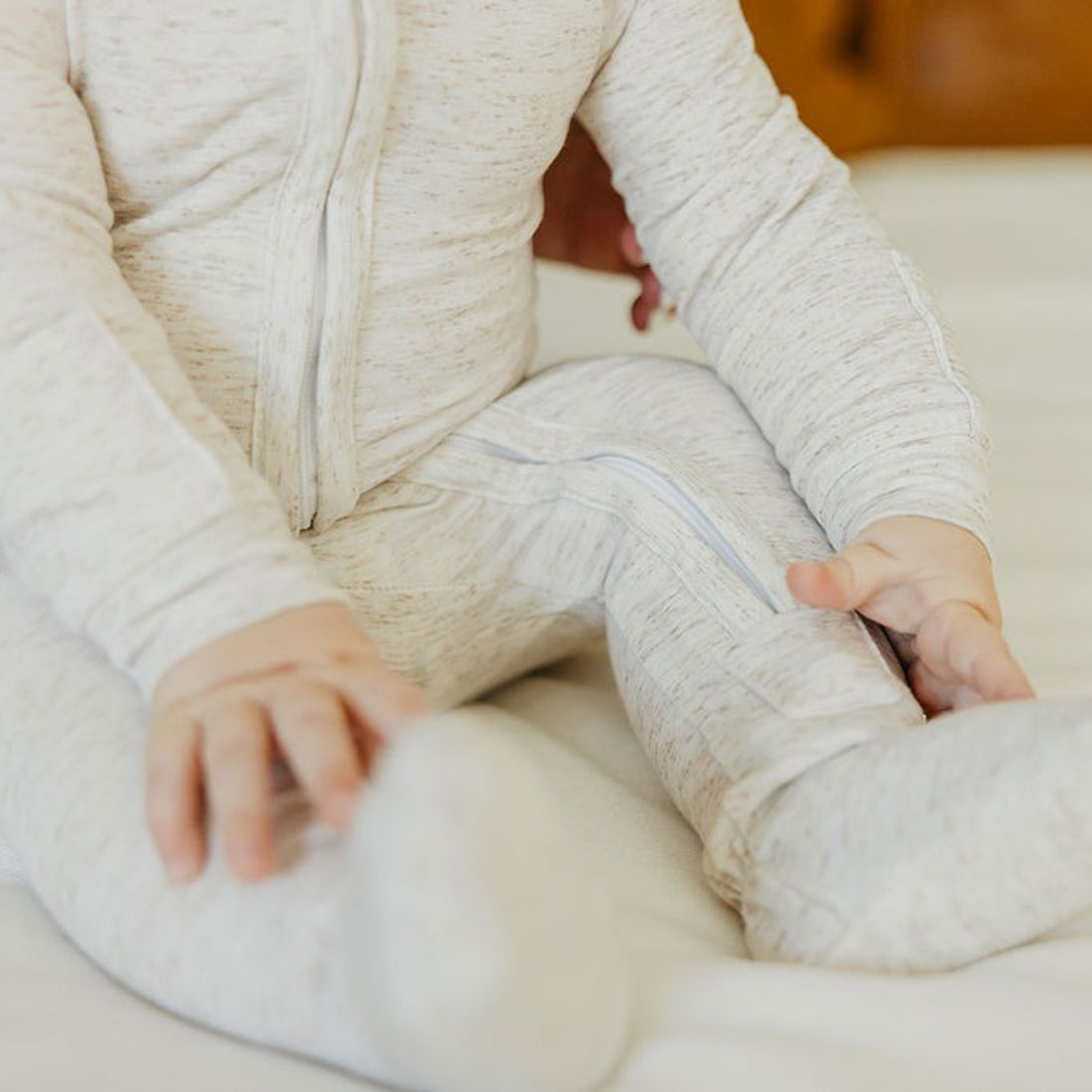 Baby wearing Copper Pearl Zip-up Footie - Oat