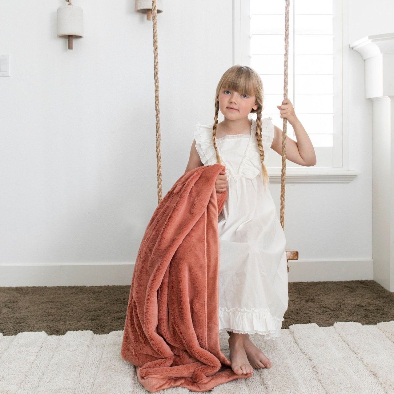 Little Girl Holding Saranoni Toddler Lush Blanket - Clay