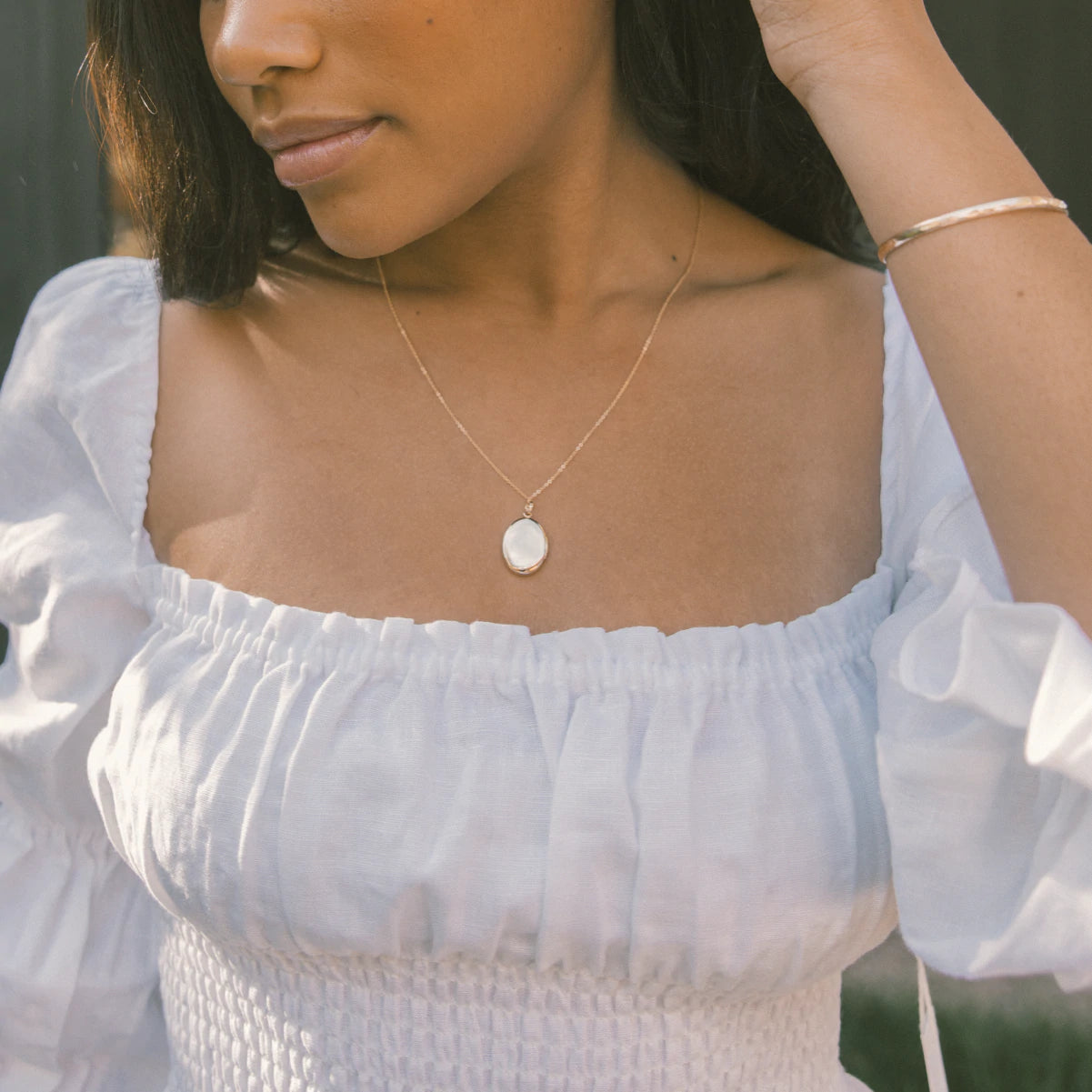 Woman Wearing Made by Mary Gold Filled Oval Locket Necklace
