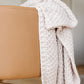 Blanket draped over Babyletto x GATHRE Capsule Bassinet - Camel