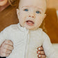 Baby wearing Copper Pearl Zip-up Footie - Oat