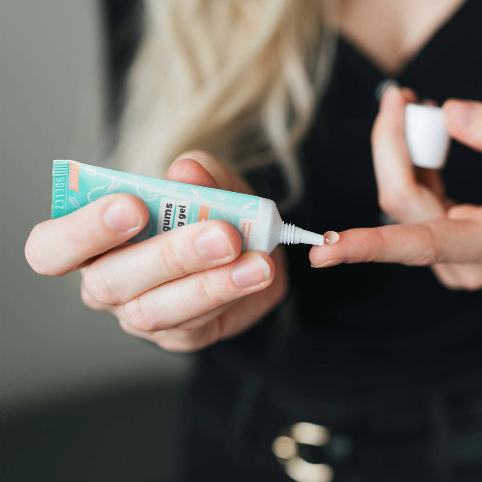 Person Squeezing gel out of Wink Well Cool Gums Teething Gel 