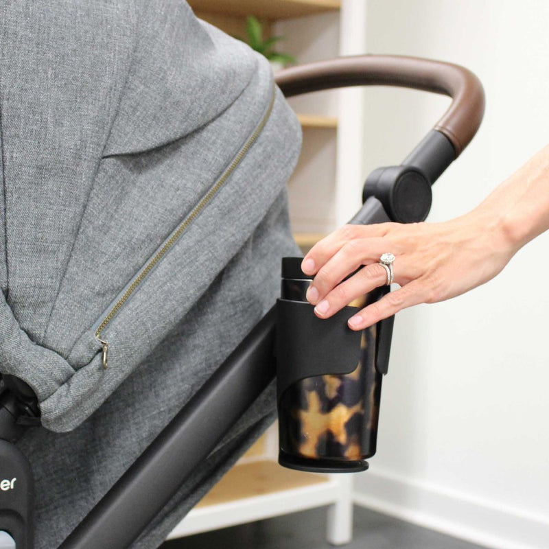 Woman putting cup into Romer Tura Stroller Cup Holder