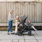 Mom pushes three children in UPPAbaby VISTA V2 and RumbleSeat V2+ Bundle - GREYSON (Charcoal Melange)