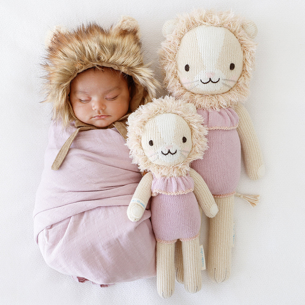 Newborn baby sleeping next to Cuddle and Kind Savannah the Lion