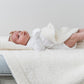 Baby laying on Saranoni Receiving Bamboni Blanket - Ivory