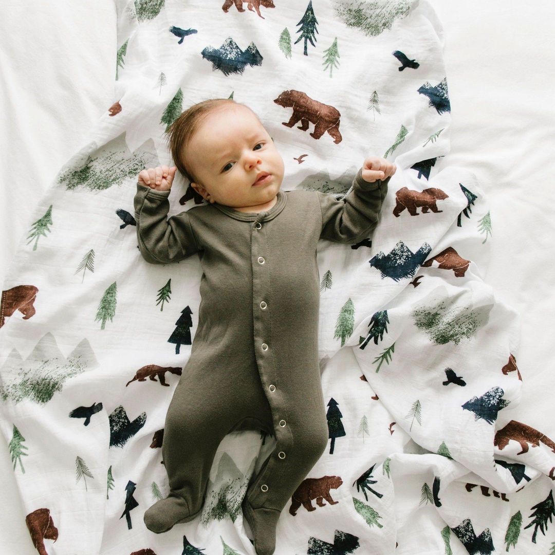 Baby laying on Saranoni Bamboo Muslin Swaddle Blanket - Yosemite