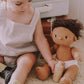 Baby playing with Olli Ella Dinkum Doll Bottle