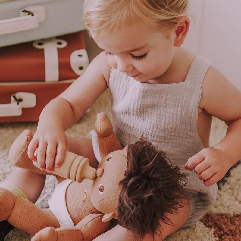 Baby playing with Olli Ella Dinkum Doll Bottle