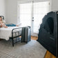 Family in bed with SlumberPod Privacy Pod with Fan - 3.0 in room