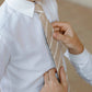 Closeup of father putting Boon Ties Boys' Tie - La Jolla on son