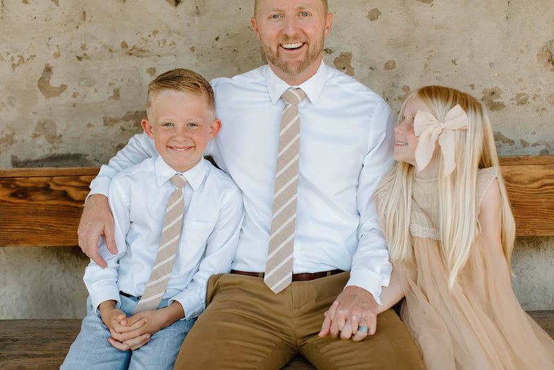 Father sits with daughter and son who is wearing Boon Ties Boys' Tie - La Jolla