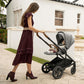 Woman pushes baby in Nuna MIXX Next Stroller with Magnetic Buckle