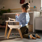 Child playing next to Maxi-Cosi Moa 8-in-1 High Chair