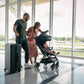 Couple pushes Nuna TRVL Stroller through airport