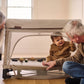Grandparents playing with toddler inside UPPAbaby REMI Playard - Charlie