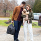 Parents holding baby and UPPAbaby REMI Playard