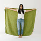 Woman holding Clementine Kids Cotton Muslin Reversible Throw Blanket - Large - Clementine
