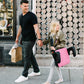 Dad and child holding Clek Olli Backless Booster Seat - Flamingo