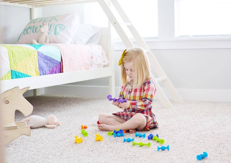 Child Playing with Fat Brain Toys Squigz Starter Set