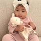 Baby Holding Itzy Ritzy Bitzy Crinkle Sensory Toy with Teether - Bunny