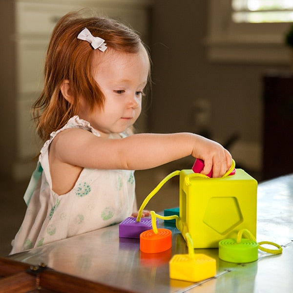 Child Playing with Fat Brain Toys OombeeCube